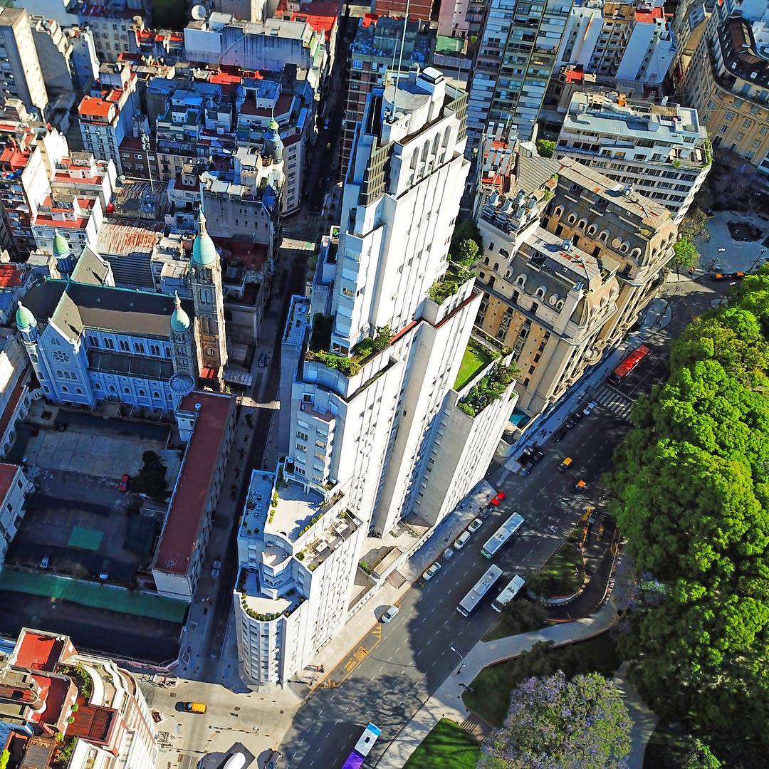 Motorcycle Drone Photography Tours in Buenos Aires | www.photodronetour.com * 
Kavanagh building - a story of forbidden love * 
Edificio Kavanaugh - la historia de un amor prohibido * 
The Kavanagh Building was born from the despair, spite and pride of a legendary woman. The tale begins in the 1930s, when Corina Kavanagh was a rich, beautiful and determined woman. Her family was extremely wealthy but with no patrician “old money” blood in their lineage. The aristocracy of Argentina looked down on them and disparagingly called them “new rich.” During those years Corina had maintained a love affair with the young high-born son of Mercedes Castellanos de Anchorena, who strongly opposed the relationship and managed to end it. 
Corina Kavanagh, hurt and humiliated, dedicated to take revenge.  The Basilica of the Holy Sacrament, was originally the private mausoleum of the Anchorenas, who lived nearby across the San Martin Plaza in the mansion which is now the Argentine Foreign Ministry. Corina bought a vacant lot right in front of the Basilica and contracted architects to design and construct an enormous building with a single purpose: to completely obstruct the view of the Anchorena church from as many angles as possible, but mainly from the windows of the Anchorena mansion.

Construction began in late 1934 and just 14 months later in early 1936, the Kavanagh Building was complete.  The Kavanagh was the tallest reinforced concrete structure in the world and for many years remained the tallest building in Latin America.

#Kavanaghbuilding #Kavanaghbuildingbuenosaires #Kavanaghbuildingba #CorinaKavanagh #Kavanaghlovestory #photodronetour #motorcycletour #privatetour #buenosaires #buenosairestour #buenosairestourist #buenosairestourism #droneselfie #dronephotography #droneinstagram #instadrone #instadroned #buenosairescity #buenosairesphoto #ba #bsas #bsascity #bsas_streetphotography #droneofficial #droneoftheday #drone #drones #dji #aerialaesthetics #skysupply * 
Motorcycle Drone Photography Tours in Buenos Aires | www.photodronetour.com